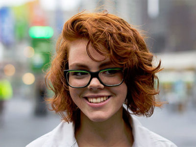 Smiling redhead girl with glasses