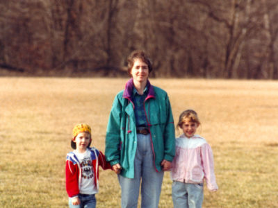 mother, son, and daughter during walk in park.