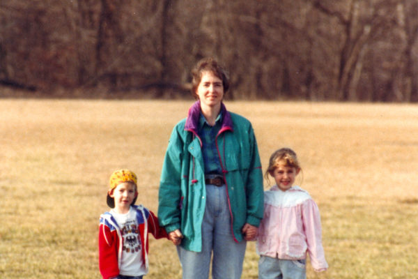 mother, son, and daughter during walk in park.