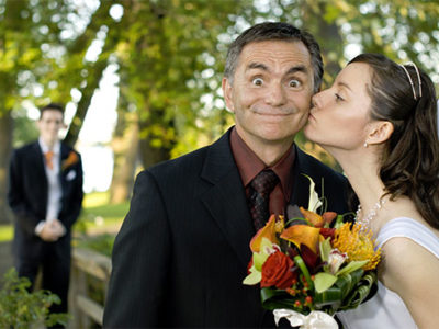 father kissing bride