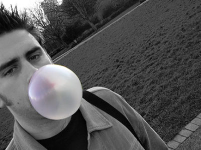 man blowing bubblegum