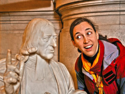 Woman posing with bust of John Wesley