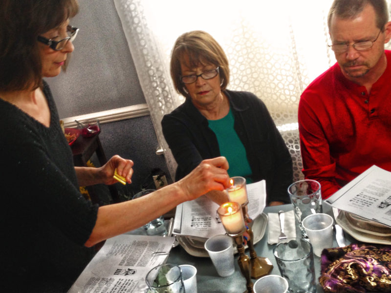 lighting Passover candle