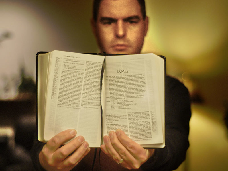 Man holding open Bible