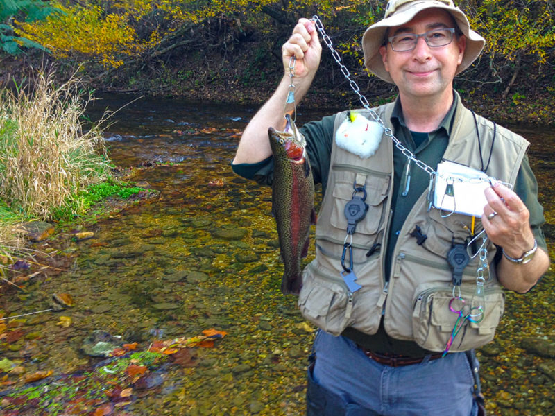 Stephen M. Miller holding a trout he caught.