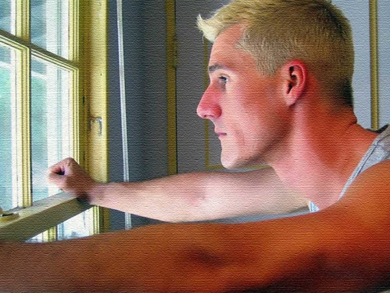 photo of blond man looking out of window