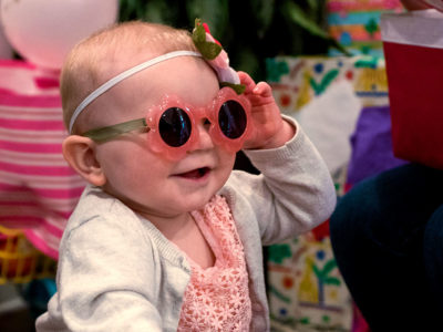 Girl in sunglasses at her first birthday party