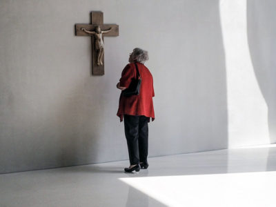 woman looking at museum art of Crucifixion of Jesus