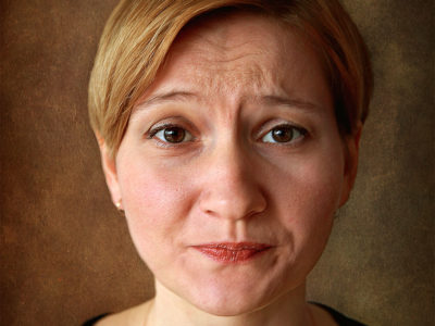 portrait of woman with sour look on face